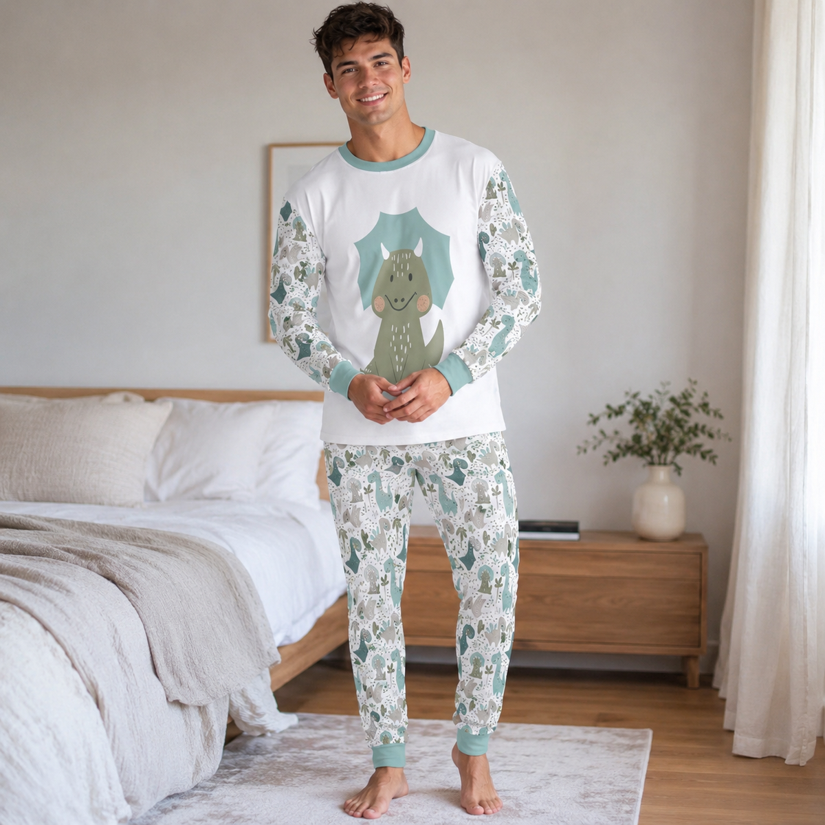 Adult wearing a cute ABDL dinosaur pajama set with a white long sleeve shirt featuring a green dinosaur and matching dinosaur print pants