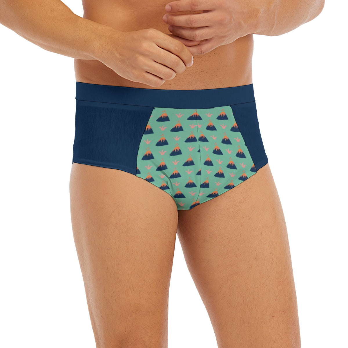 Cute men’s low-rise briefs featuring a colorful volcano print on a mint green background, with a comfortable stretchy fit. Playful ABDL and Adult Baby underwear for men.
