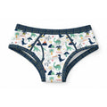 White 100% cotton adult briefs featuring an all-over pattern of navy and green dinosaurs, palm trees, volcanoes, ROAR text, and dark navy blue elastic trim.